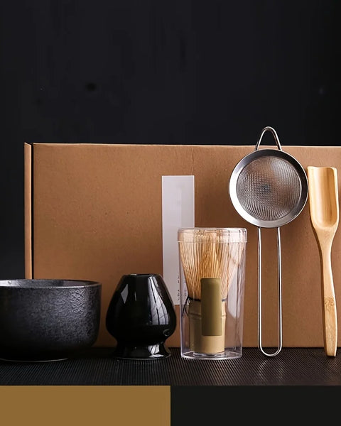 Matcha gift set with matte black bowl, whisk holder, bamboo whisk, sieve, scoop and spoon in kraft gift box